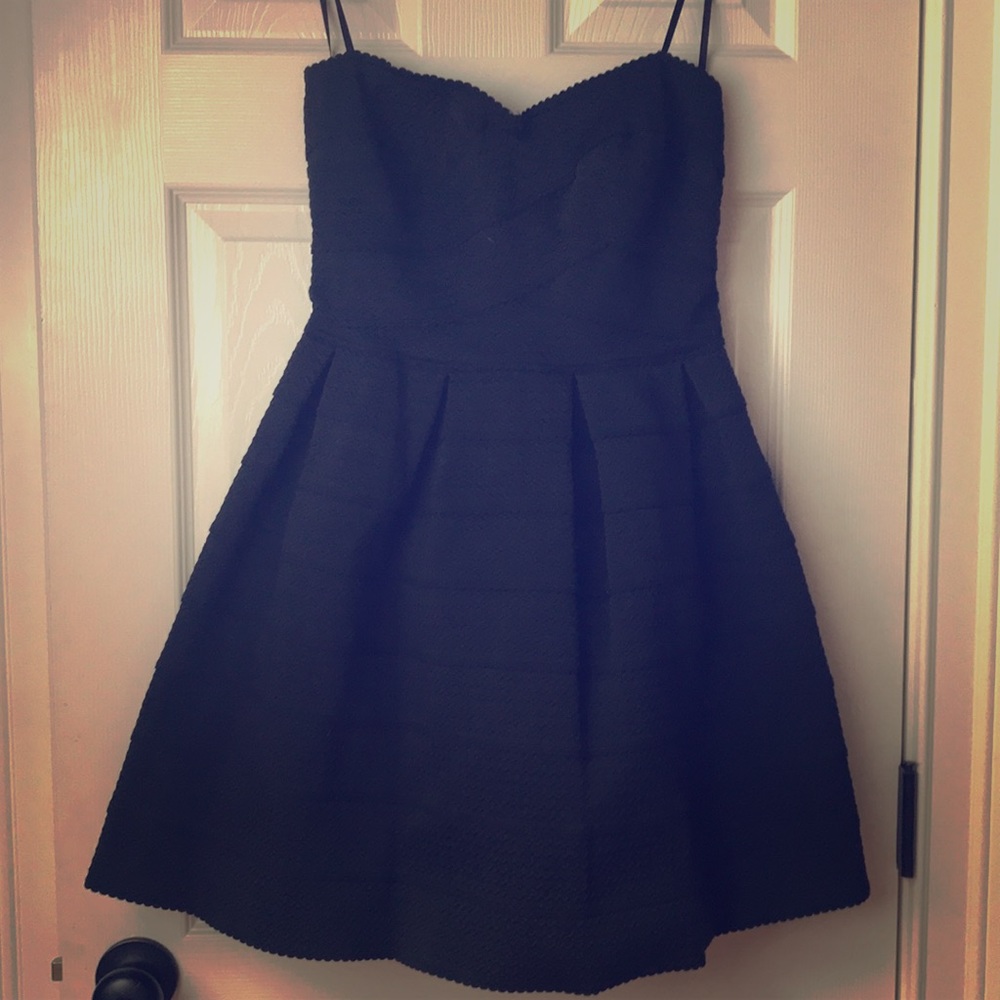Textured strapless black dress.
